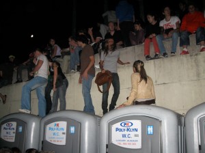 Can't see the fireworks? Climb on the portapotties!
